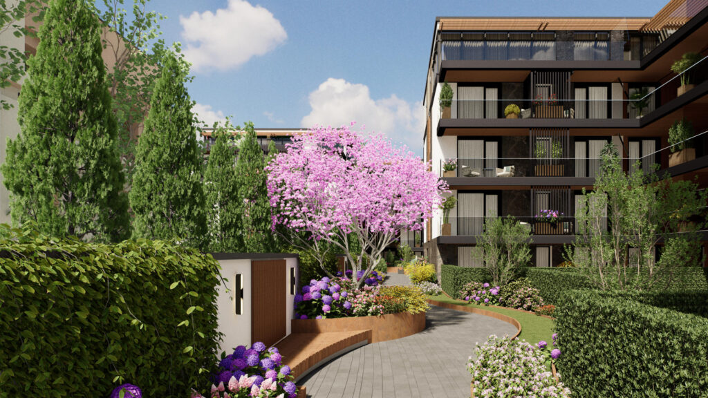 Alee pietonală în ansamblul ARQA Jolie Village, înconjurată de spații verzi bine întreținute și un design exterior modern